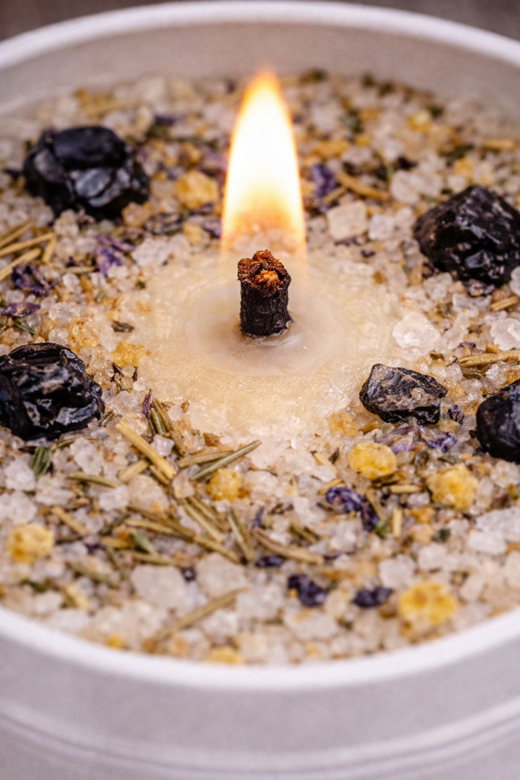 Close-up of the House of the Root™ Uncrossing & Cleansing Ritual Candle highlighting the flame, dressed wax, herbs and salts used for focused spiritual cleansing work.