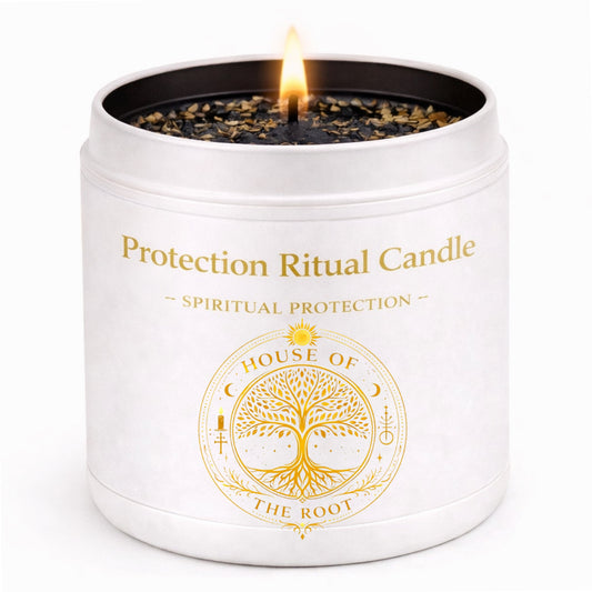 Protection Ritual Candle by House of the Root in a white tin with gold label and black wax, surrounded by protective herbs, garlic, rosemary, sea salt, and black stones in a spiritual ritual setting.