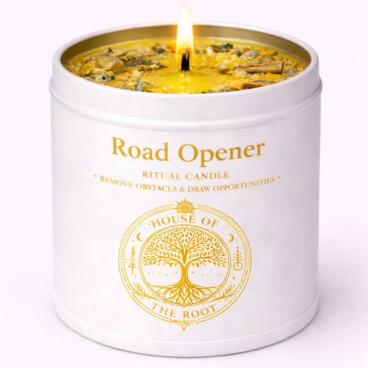 House of the Root Road Opener Ritual Candle in white tin with gold label, dressed with herbs and crystals to remove obstacles and open new opportunities. 